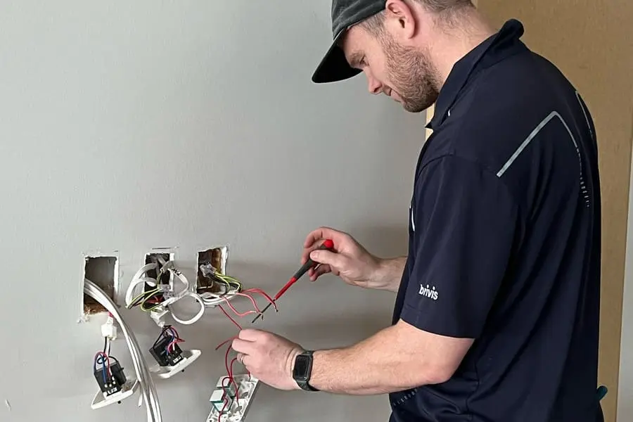 Plum electrician working on a commercial fit-out